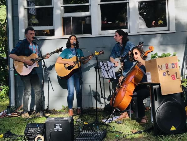 Rohini and her bandmates playing music at PorchFest in Ithaca