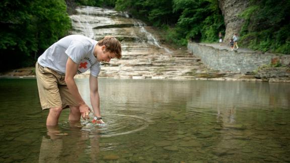 student collecting water sample