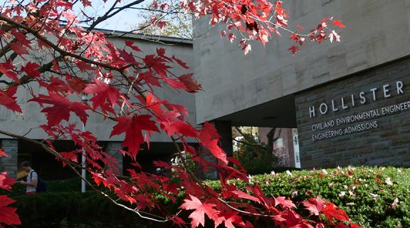 red autumn leaves on tree in front of Hollister hall