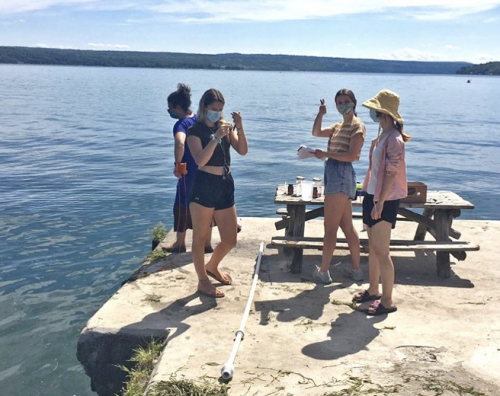 4 researchers at Taughannock State Park collecting water samples