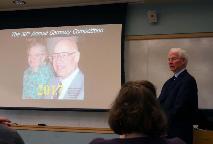 Professor Ken Hover presenting a lecture about Samuel Garmezy. Bob and his wife Alice Garmezy are featured in a photo on the screen.