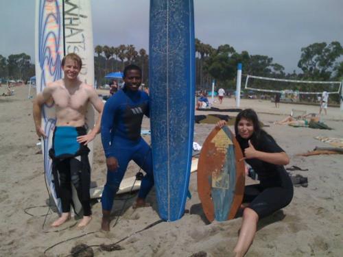 Gil with friends and surfboards at the beach
